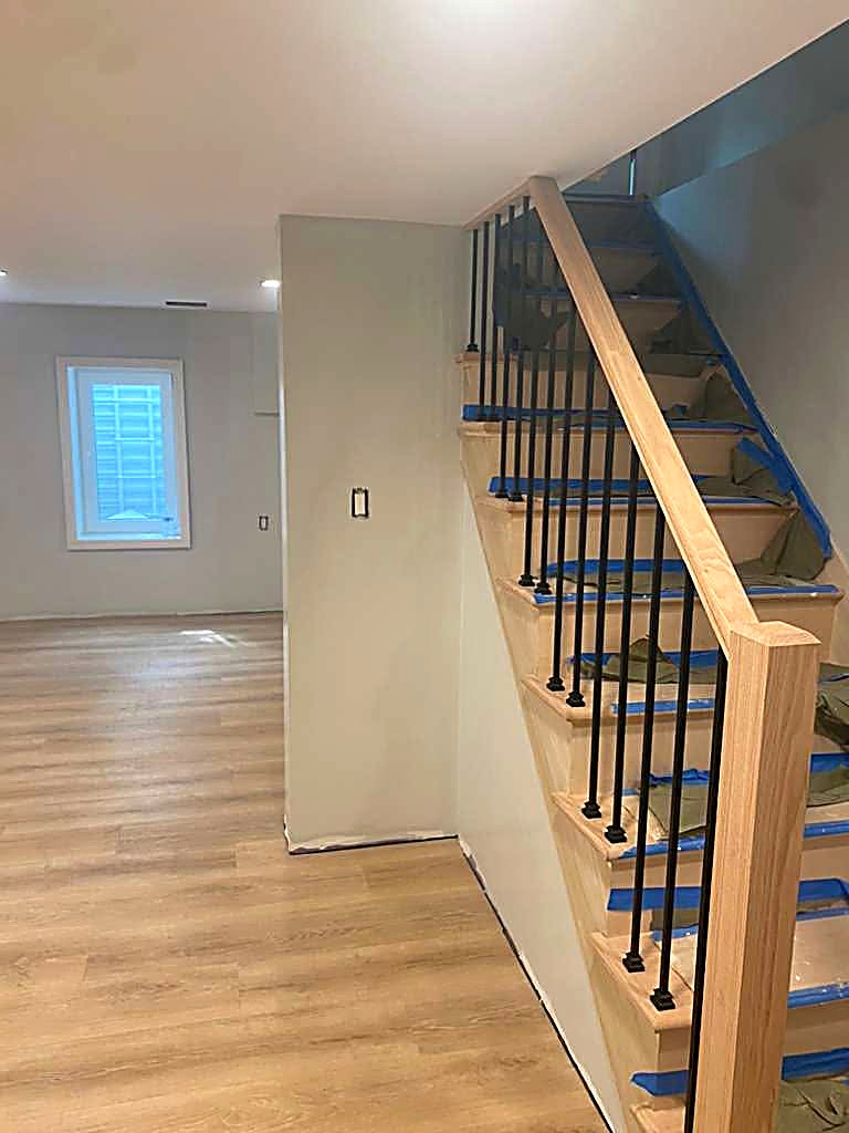 Finished oak stair rail with iron balusters and new flooring