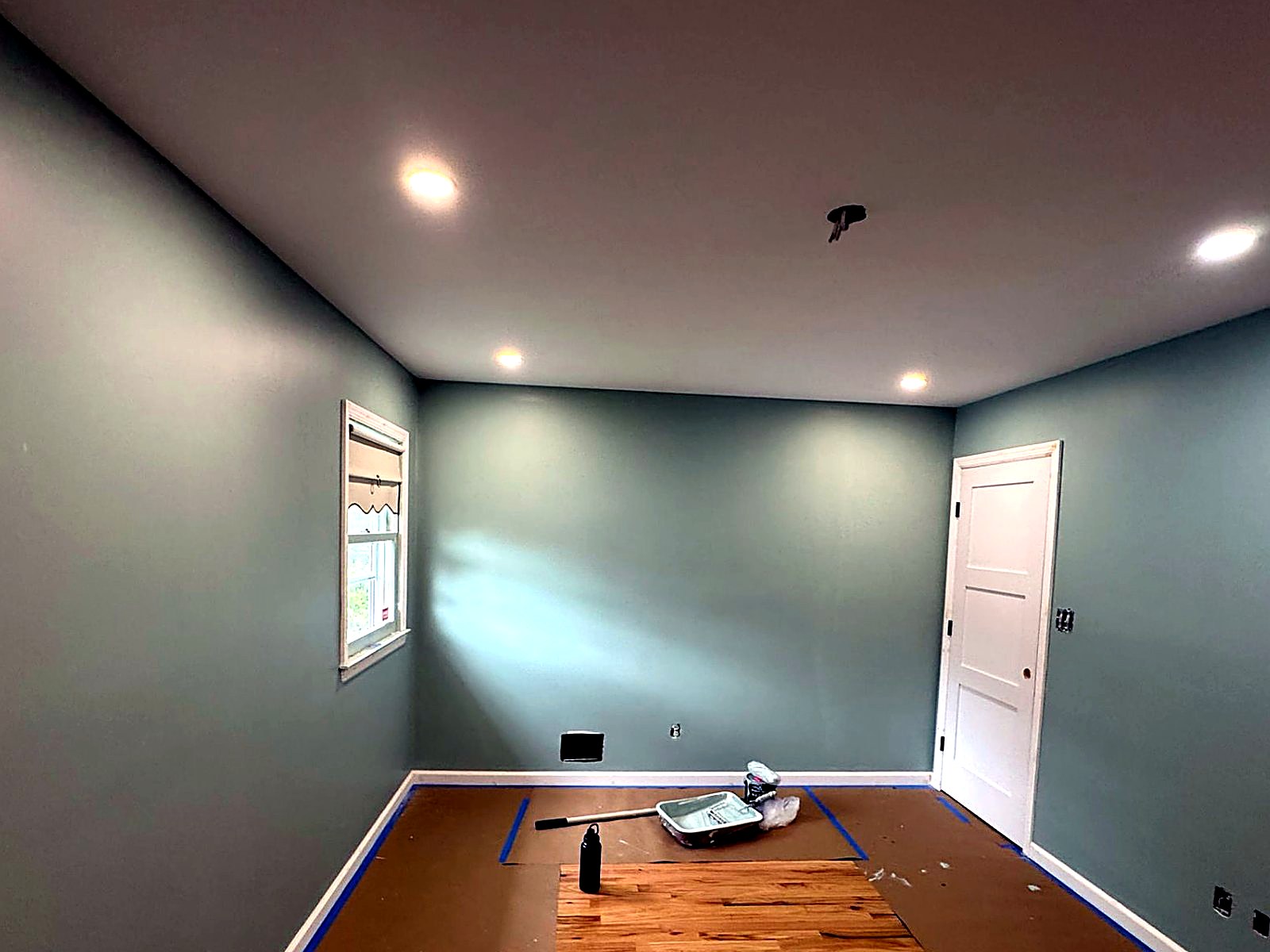 Deep sage interior repaint with sharp ceiling cut-in lines