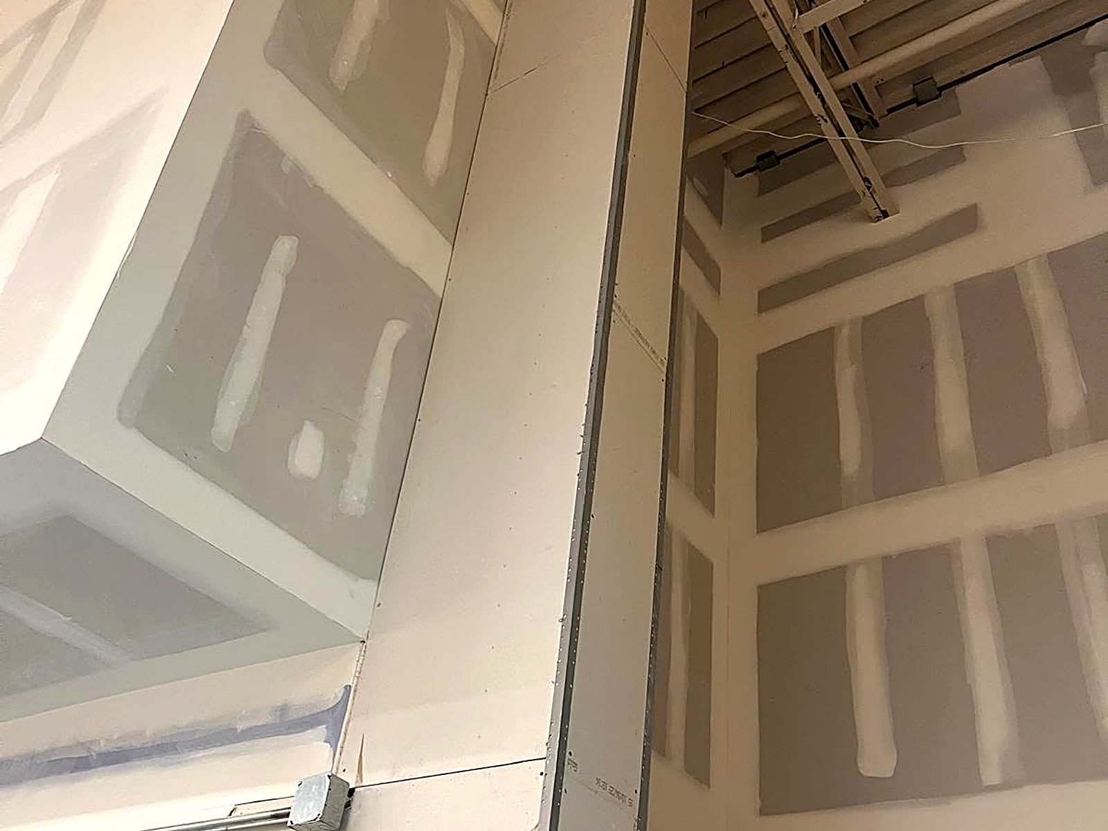 Drywall column enclosure and taped walls in a commercial interior