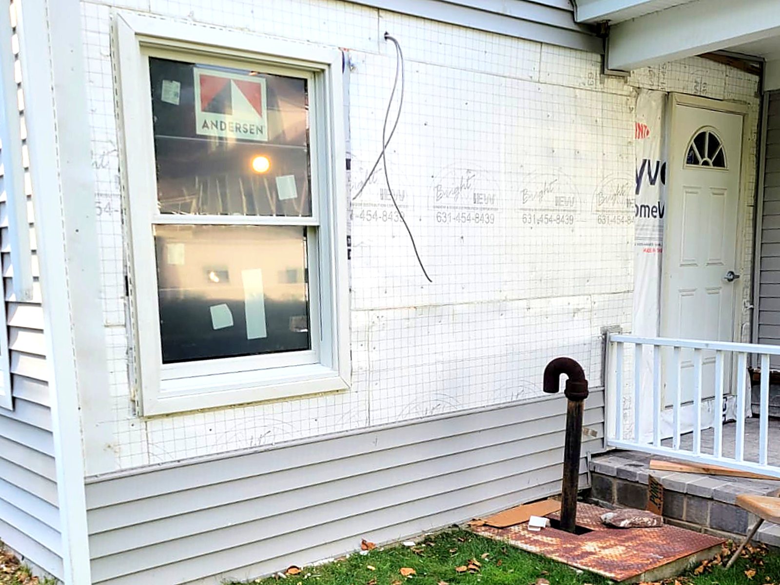 Siding and window trim replacement in progress on a home exterior