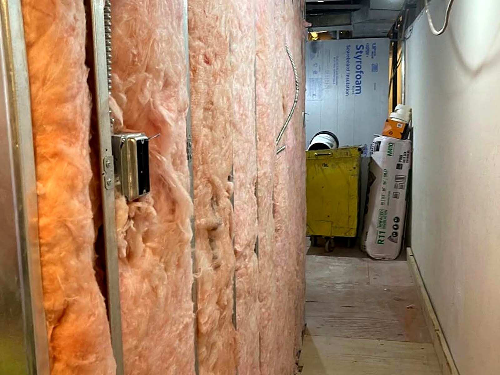 Insulated corridor partition with batt insulation set tight between steel studs