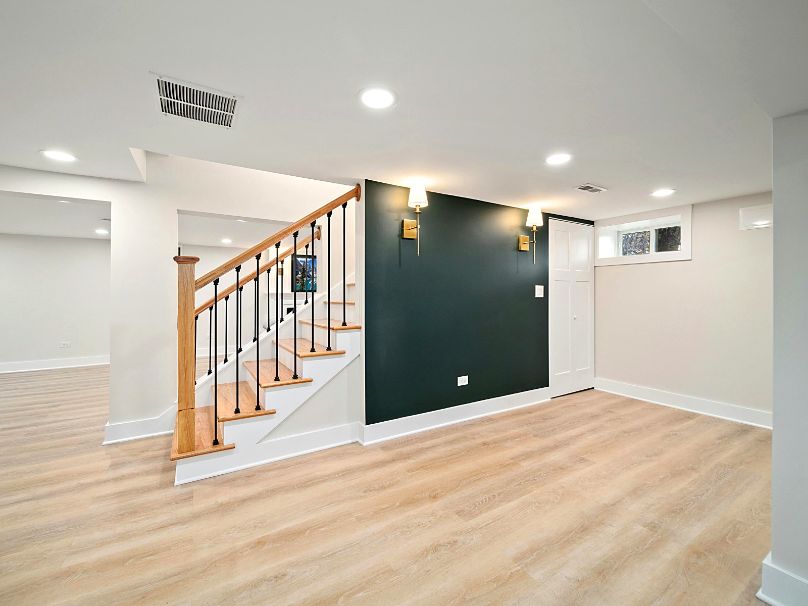 Finished lower-level remodel with new flooring, accent wall and recessed lighting