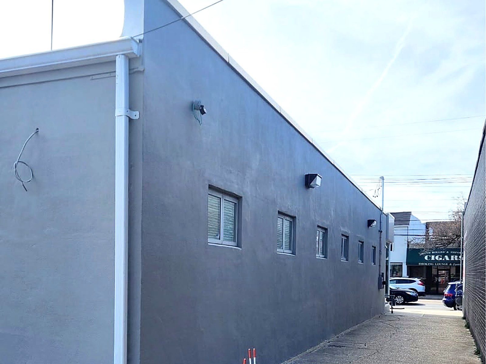 Completed exterior repaint of a commercial building in slate grey