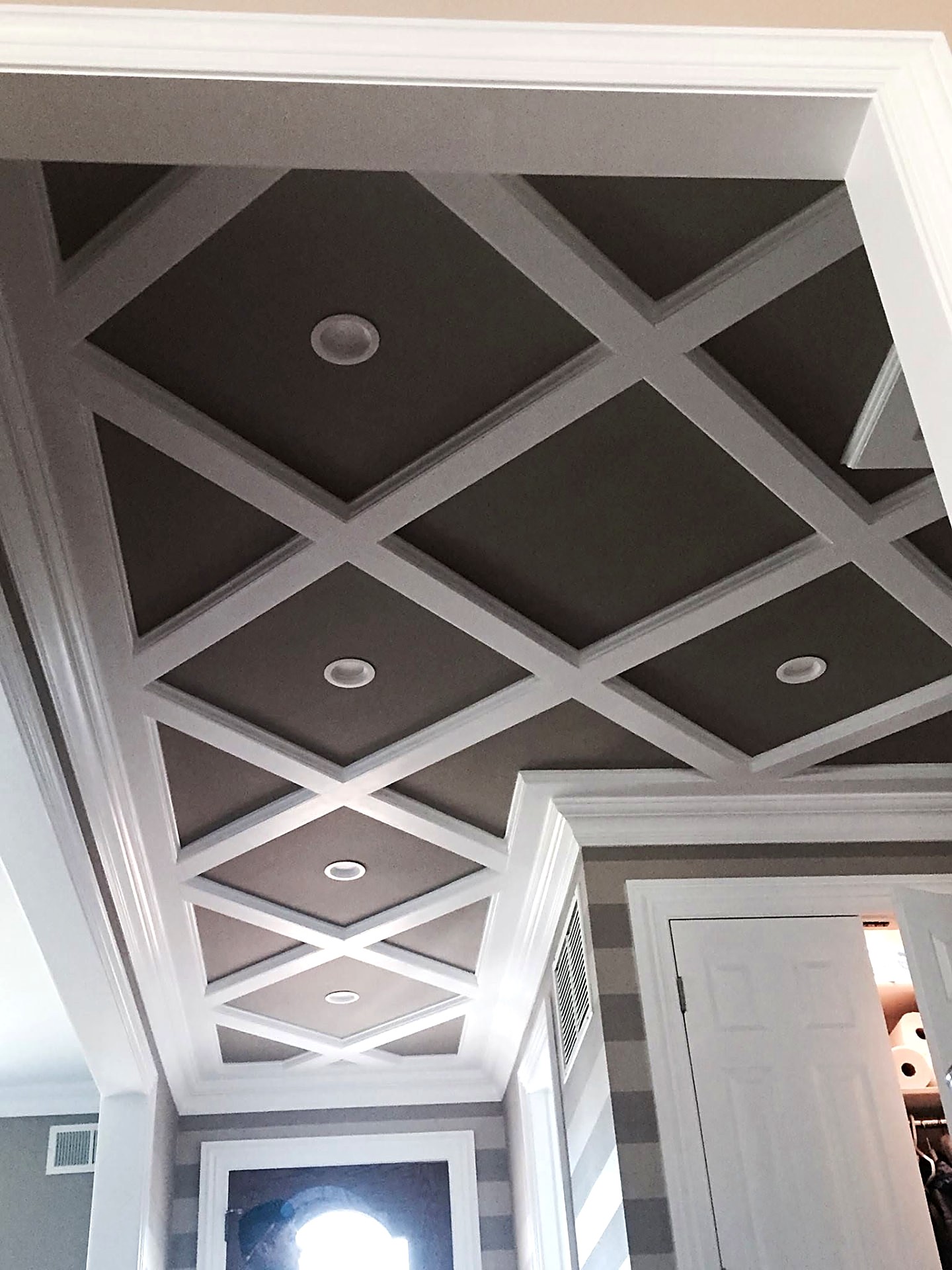 Coffered gypsum ceiling with diamond trim pattern and recessed lighting