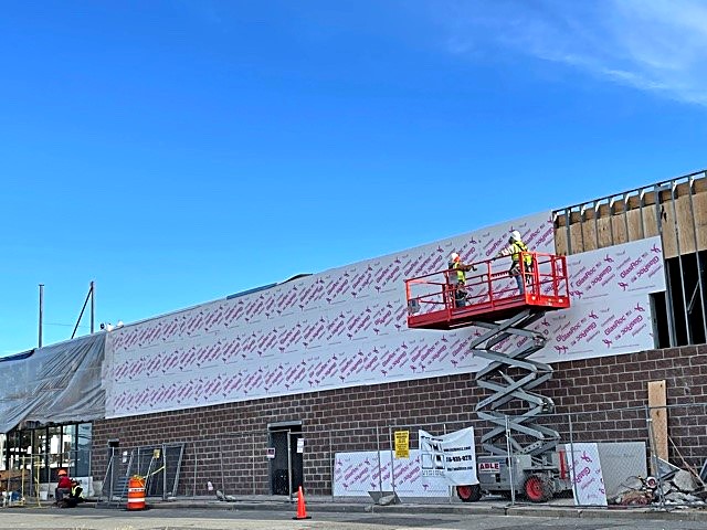 Commercial building exterior with sheathing and masonry veneer in progress