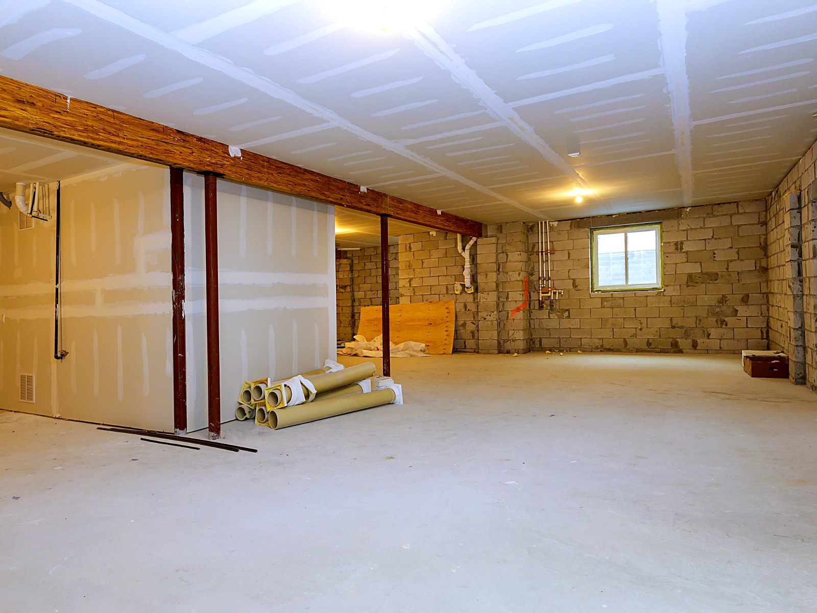 Lower-level renovation with new drywall, framing and finished ceiling