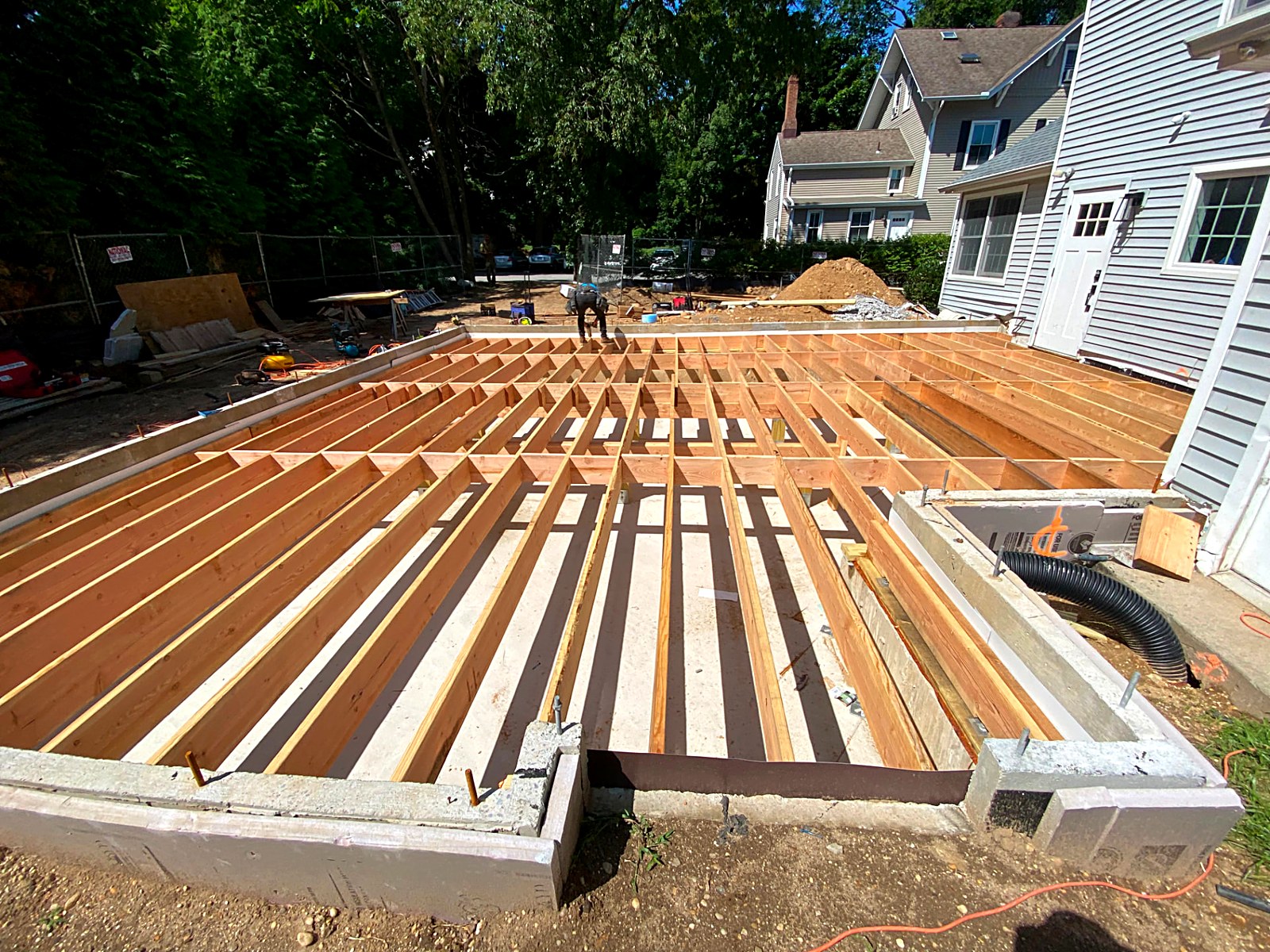 Wide deck platform framing spanning a foundation with joists laid out to code