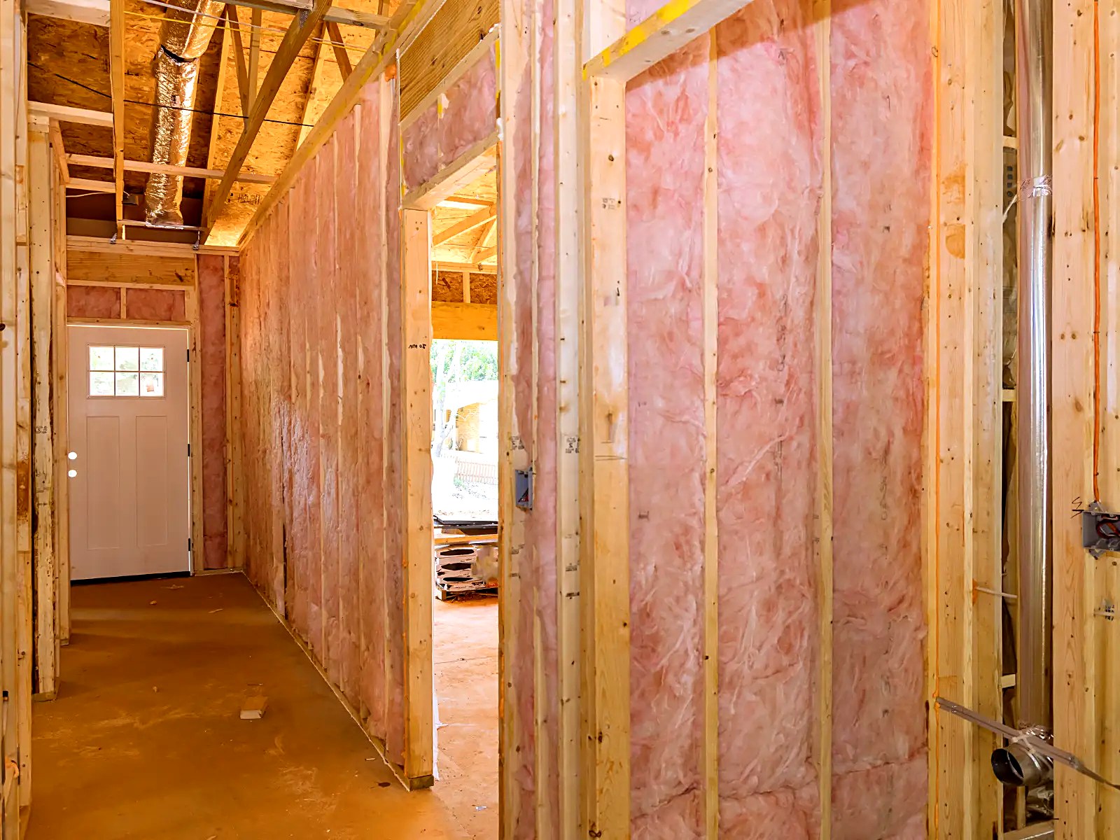 Batt insulation installed throughout framed interior partitions and corridors
