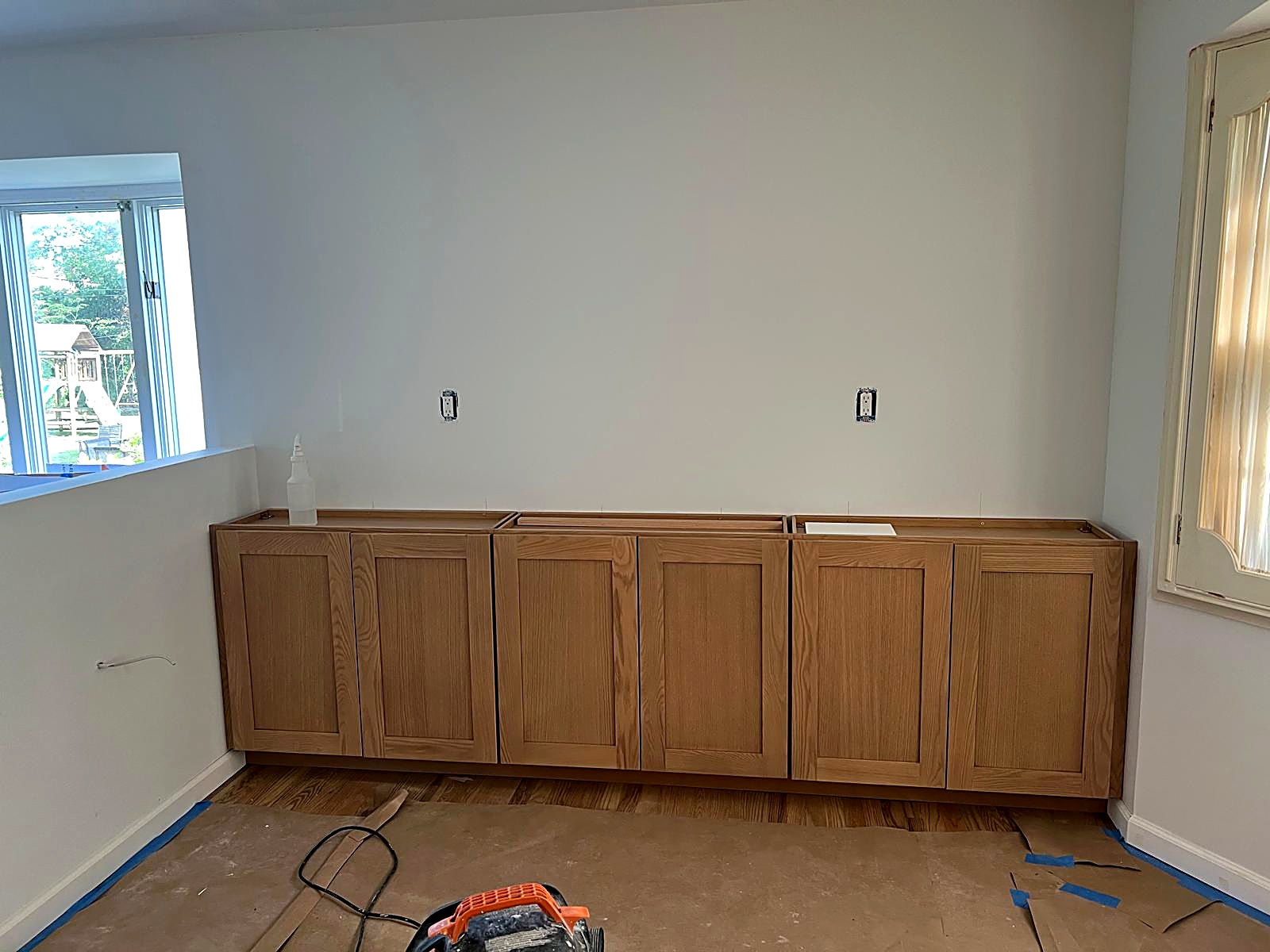 Long base cabinet run installed level along a finished wall