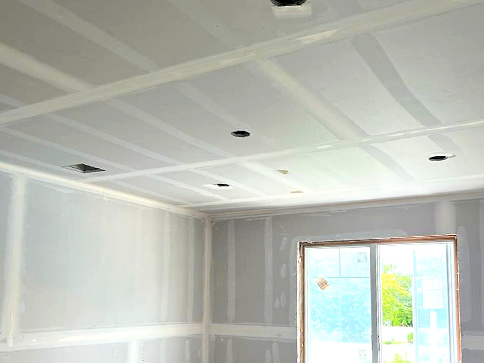 Finished drywall ceiling and walls with recessed light cutouts