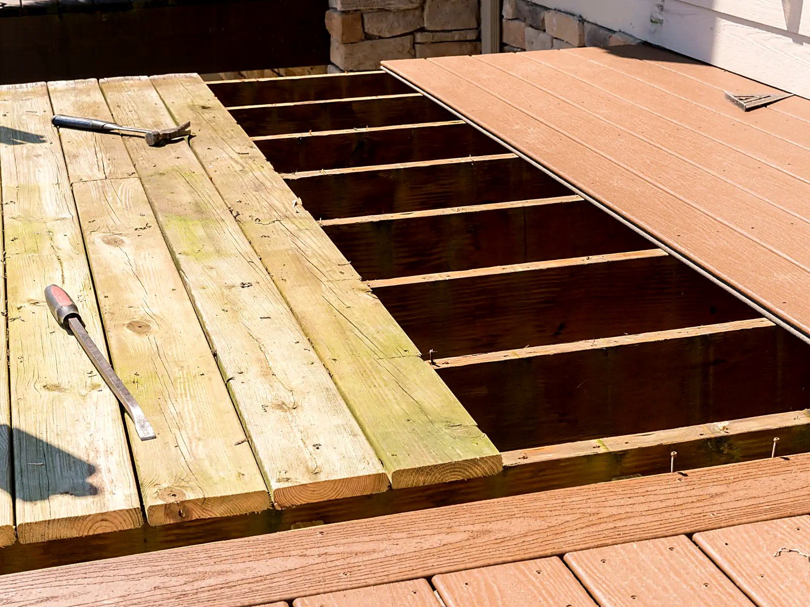 Composite decking installation replacing weathered wood boards