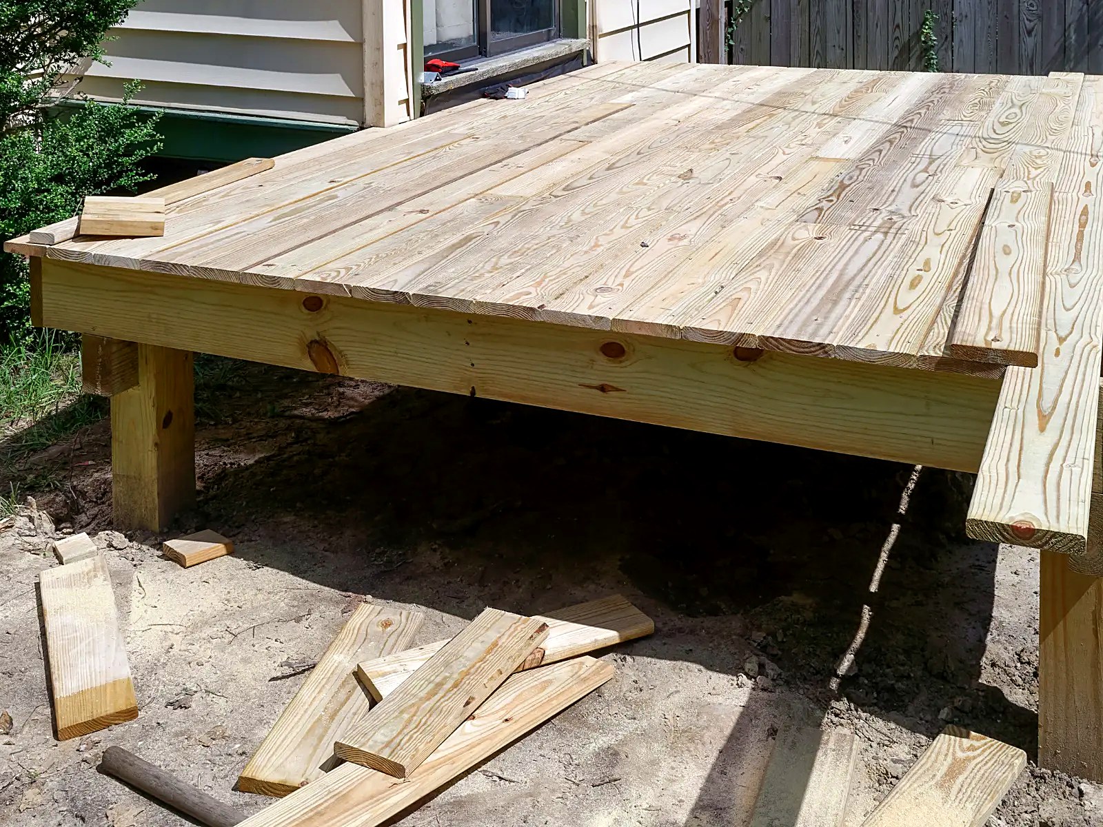Completed wood decking surface installed on a freestanding elevated deck