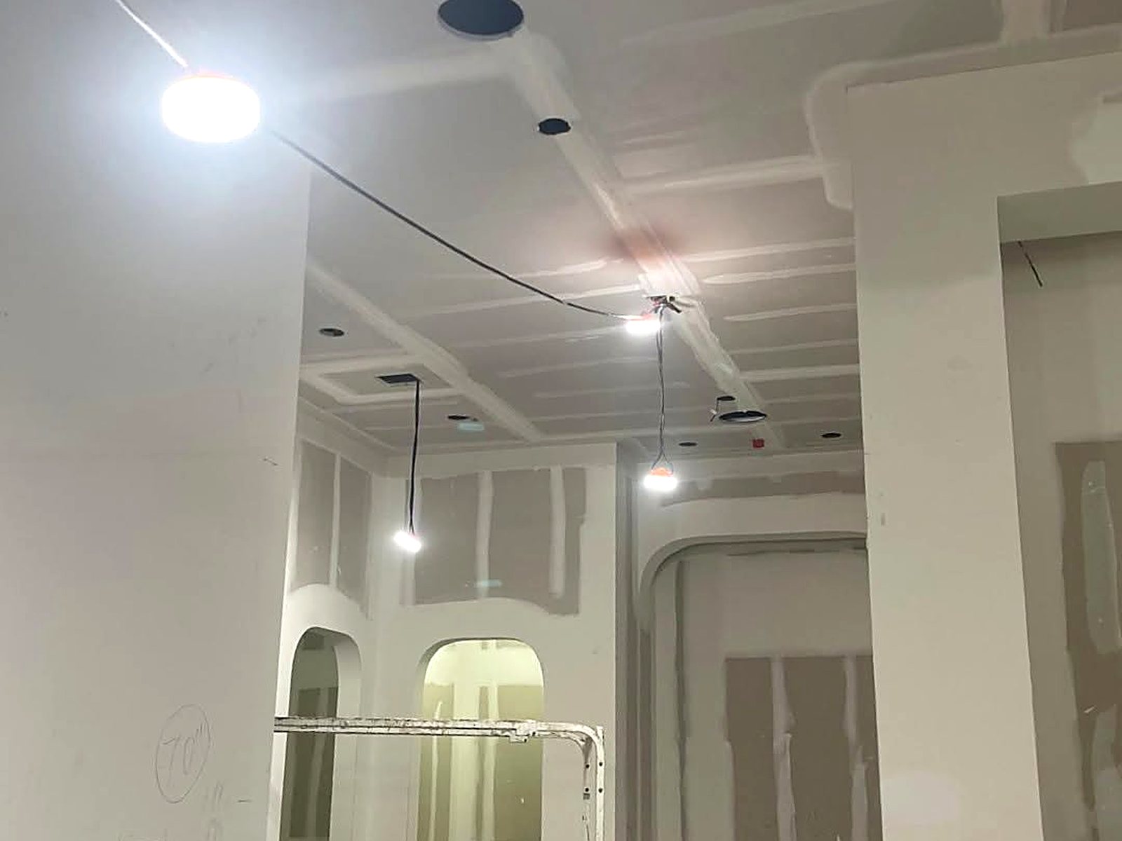 Finished drywall bulkheads and soffits in a high-ceiling commercial space