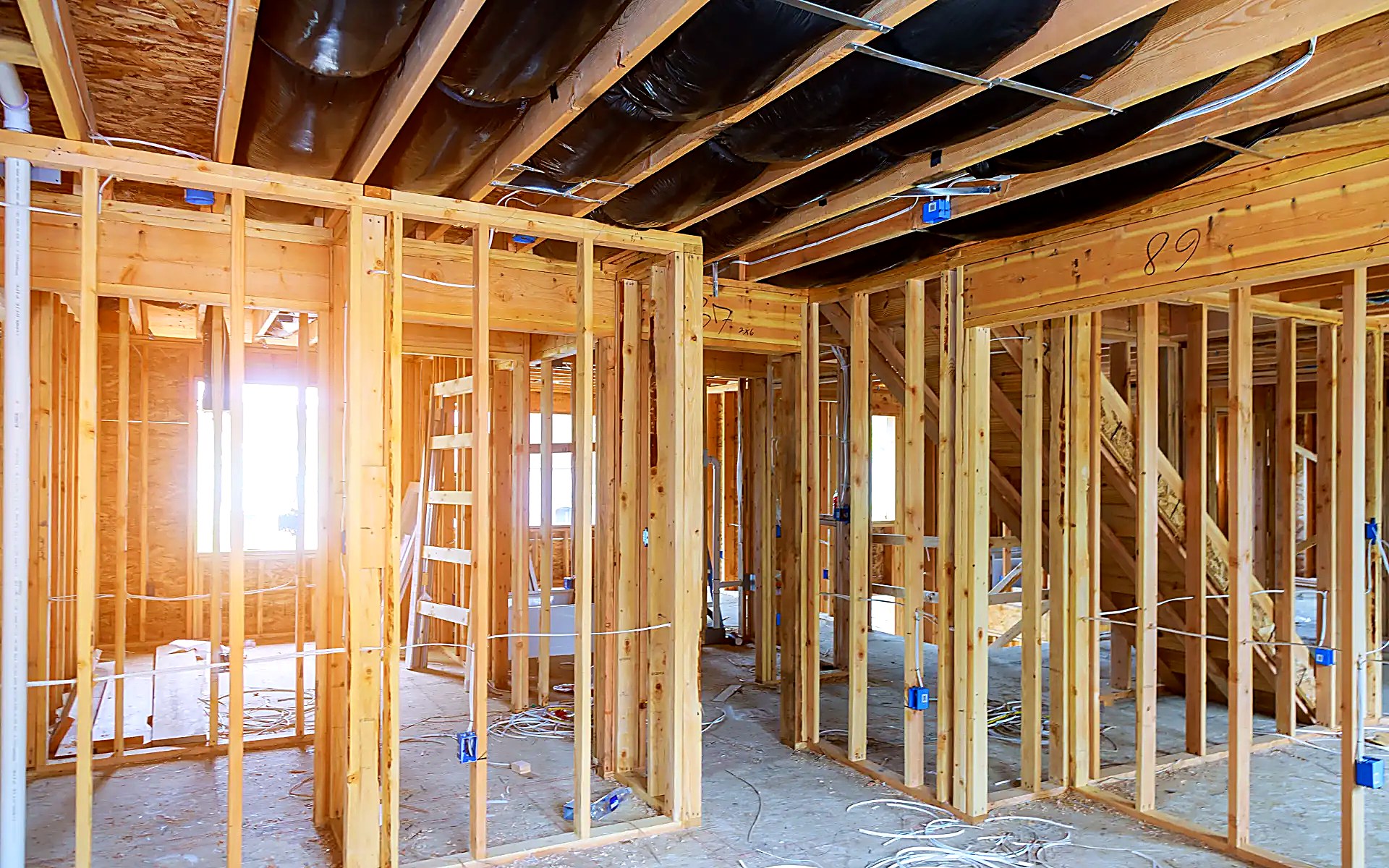 Wood framing with ductwork and electrical rough-in between studs