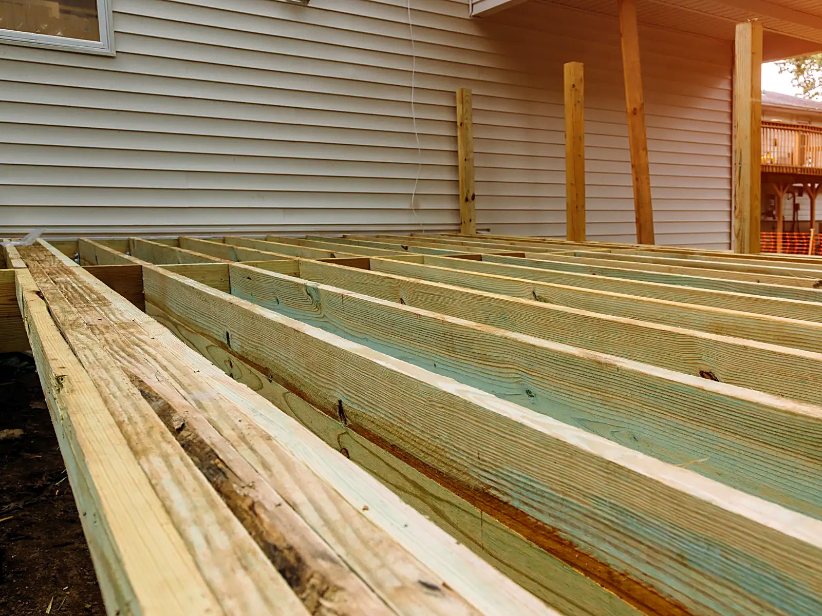 Deck joist system built along the house with support posts in place