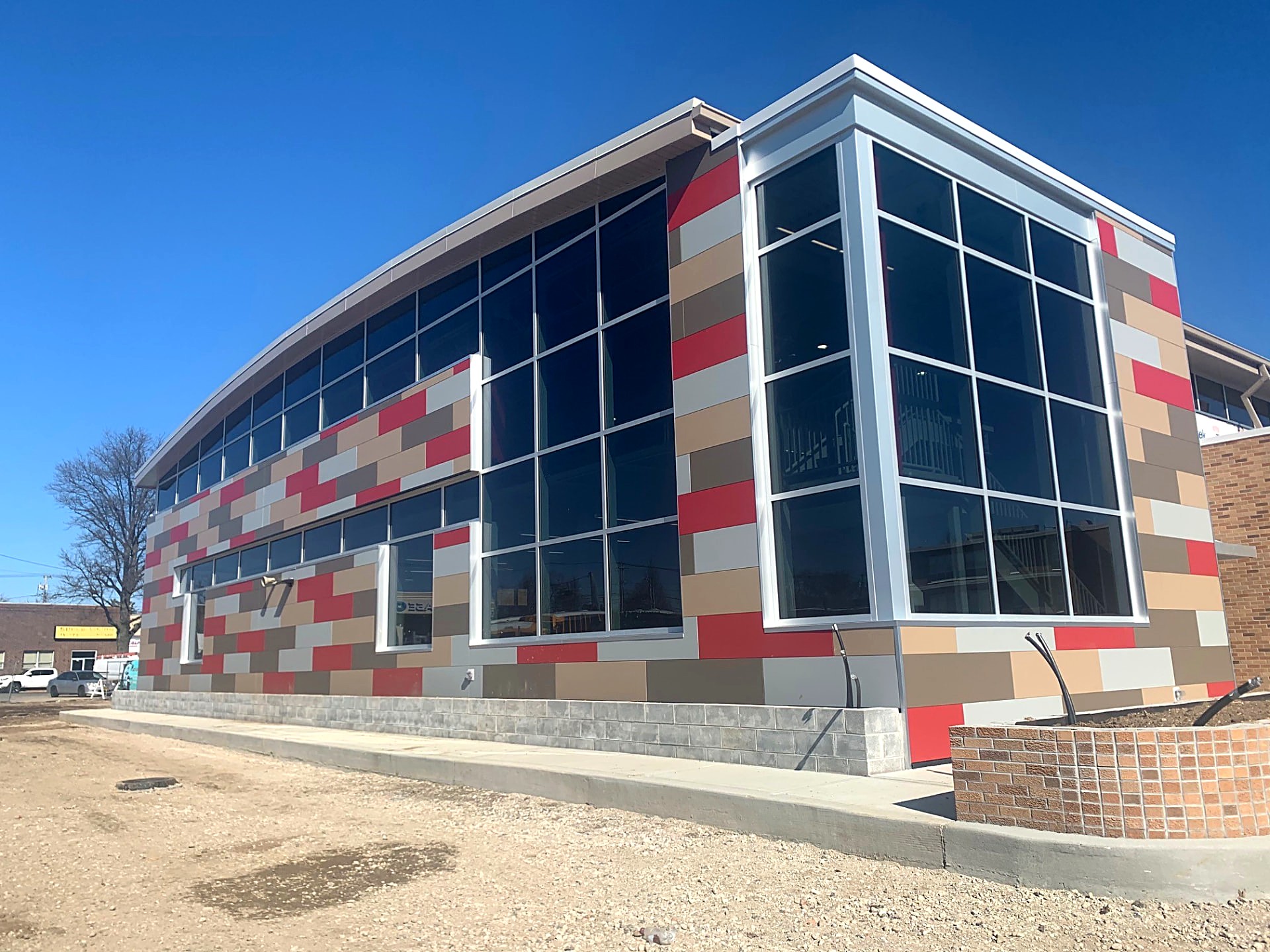 New commercial building with curved curtain wall and multi-tone panel facade