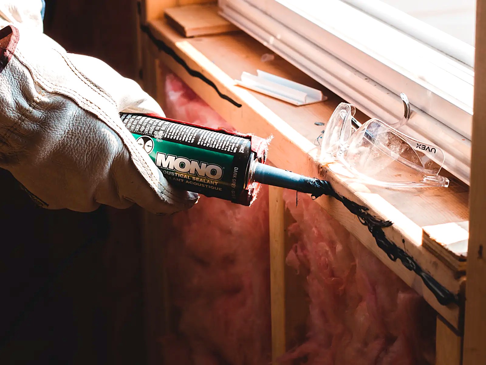 Acoustical sealant applied at a window rough opening for air-barrier continuity