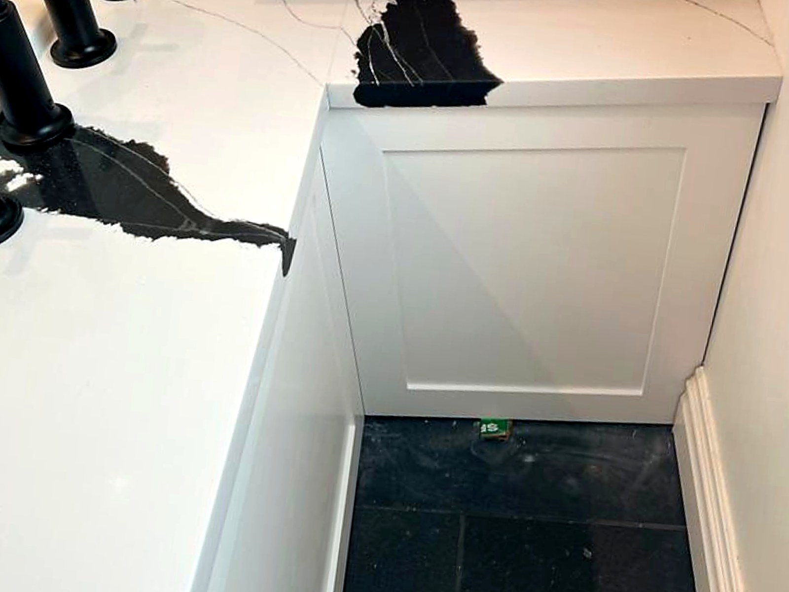 Vanity casework detail with quartz waterfall countertop and finished panel ends