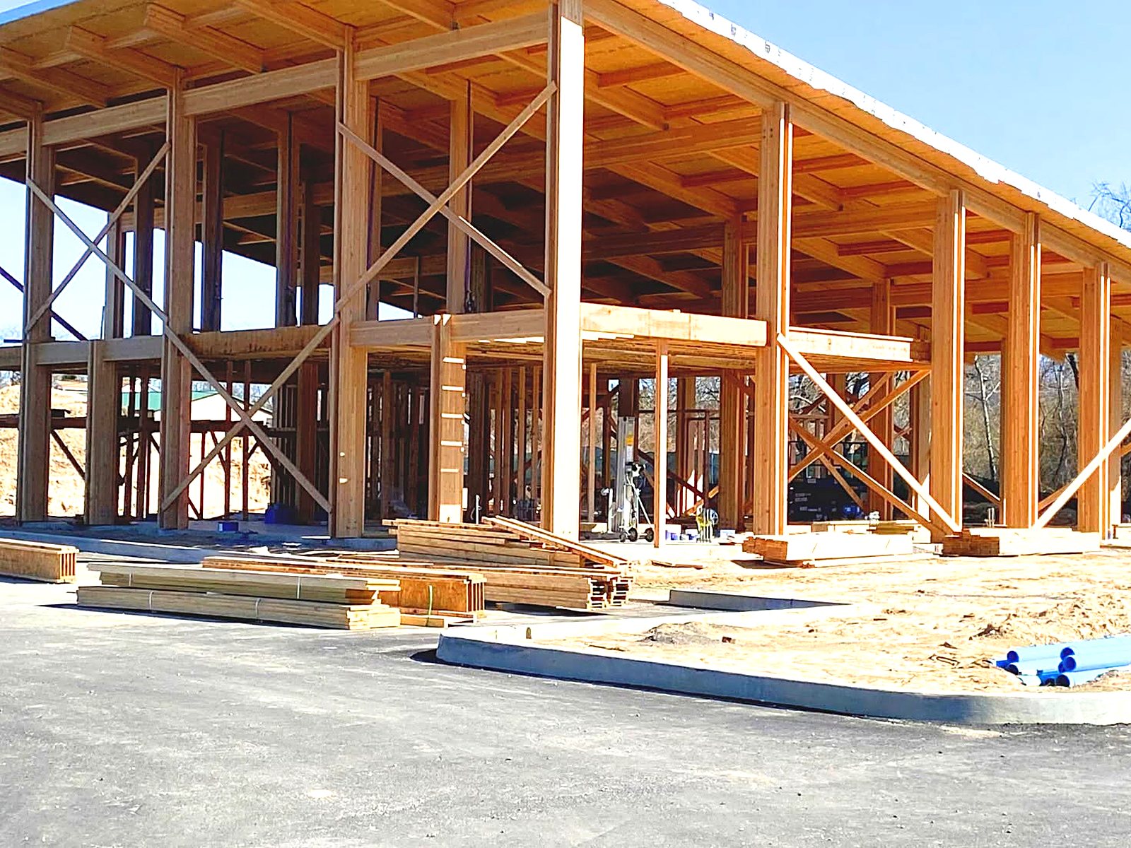 Braced glulam column and beam framing with open floor structure