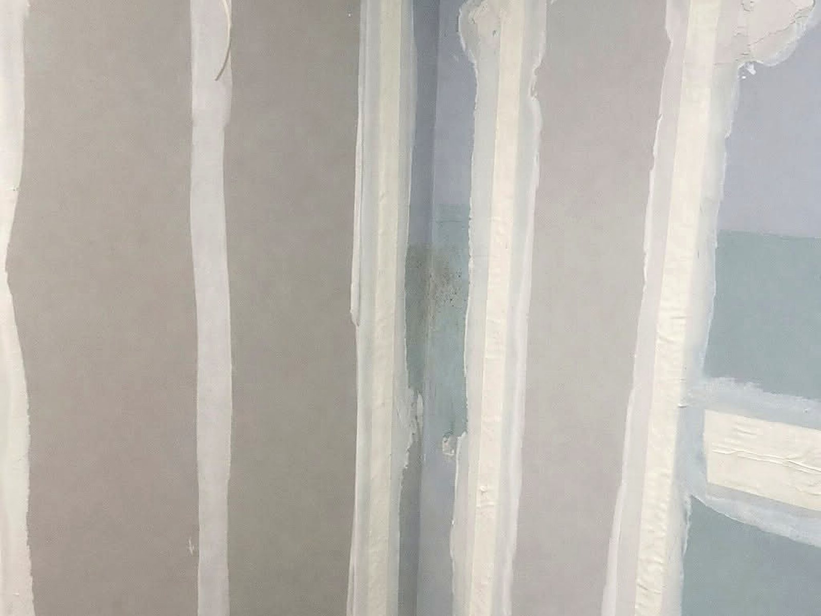 Corner detail of taped drywall seams and finished inside corners